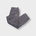 Grey Adidas trackpants showing red side piping and embroidered logo
