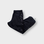 Nike trackpants in black featuring a tonal embroidered swoosh and ankle drawstrings.