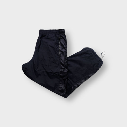 Nike trackpants in black featuring a tonal embroidered swoosh and ankle drawstrings.