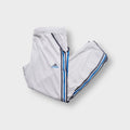 Grey Adidas trackpants with blue and dark grey side stripes and small embroidered logo.