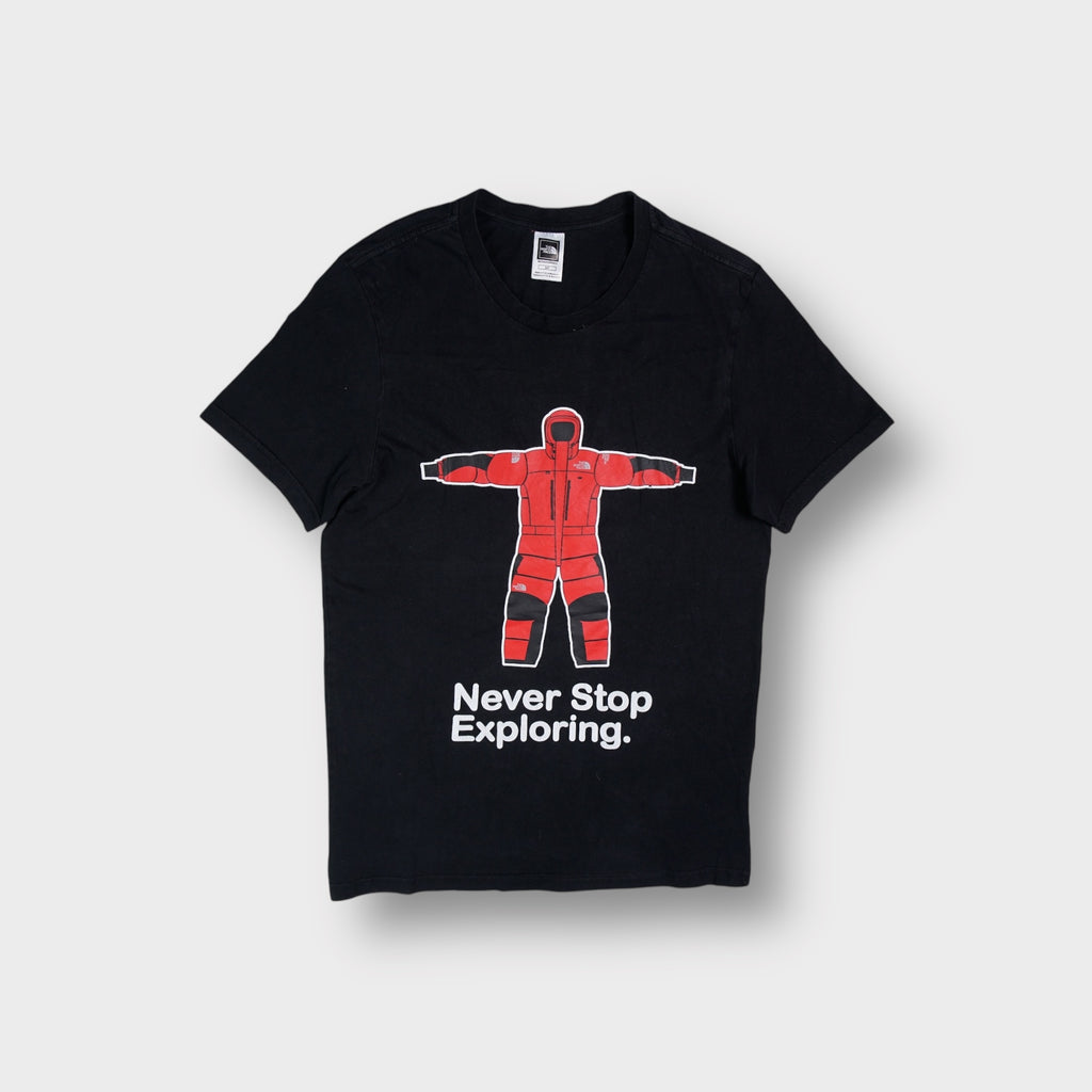 The North Face T-Shirt in black with a red expedition suit graphic on the front