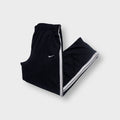 Black Nike trackpants with white side stripes and embroidered swoosh