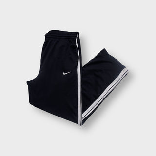 Black Nike trackpants with white side stripes and embroidered swoosh