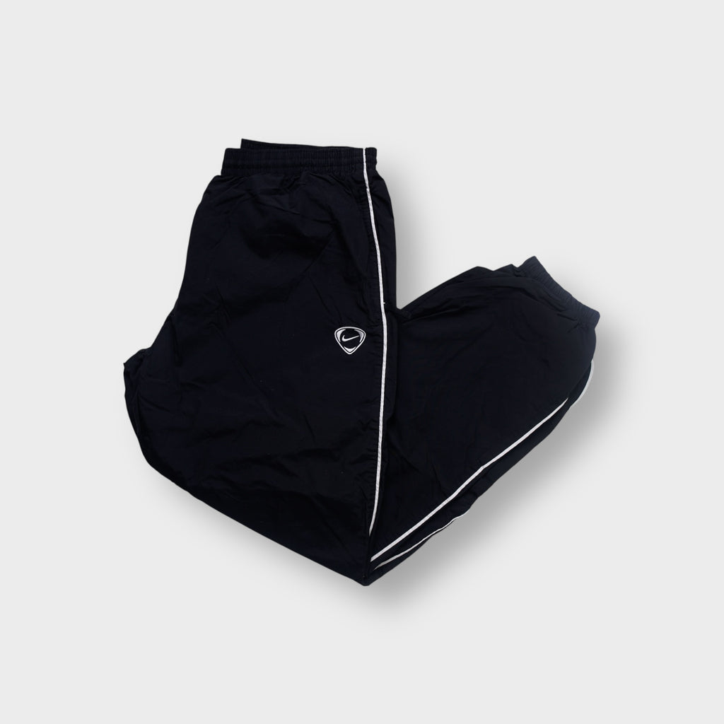 Nike trackpants in black with white side piping and an embroidered shield Swoosh logo