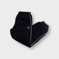 Nike trackpants in black with white side piping and an embroidered shield Swoosh logo
