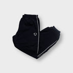 Nike trackpants in black with white side piping and an embroidered shield Swoosh logo