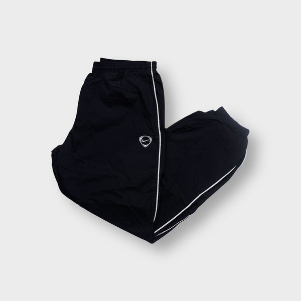 Nike trackpants in black with white side piping and an embroidered shield Swoosh logo