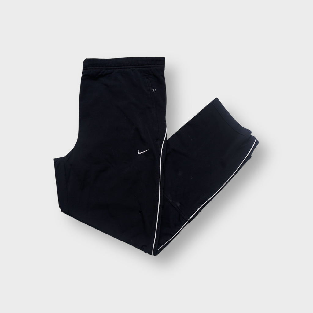 Nike black trackpants featuring side piping and small embroidered white logo