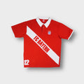 FC Bayern polo shirt in red with white collar, diagonal sash text, and embroidered crest.