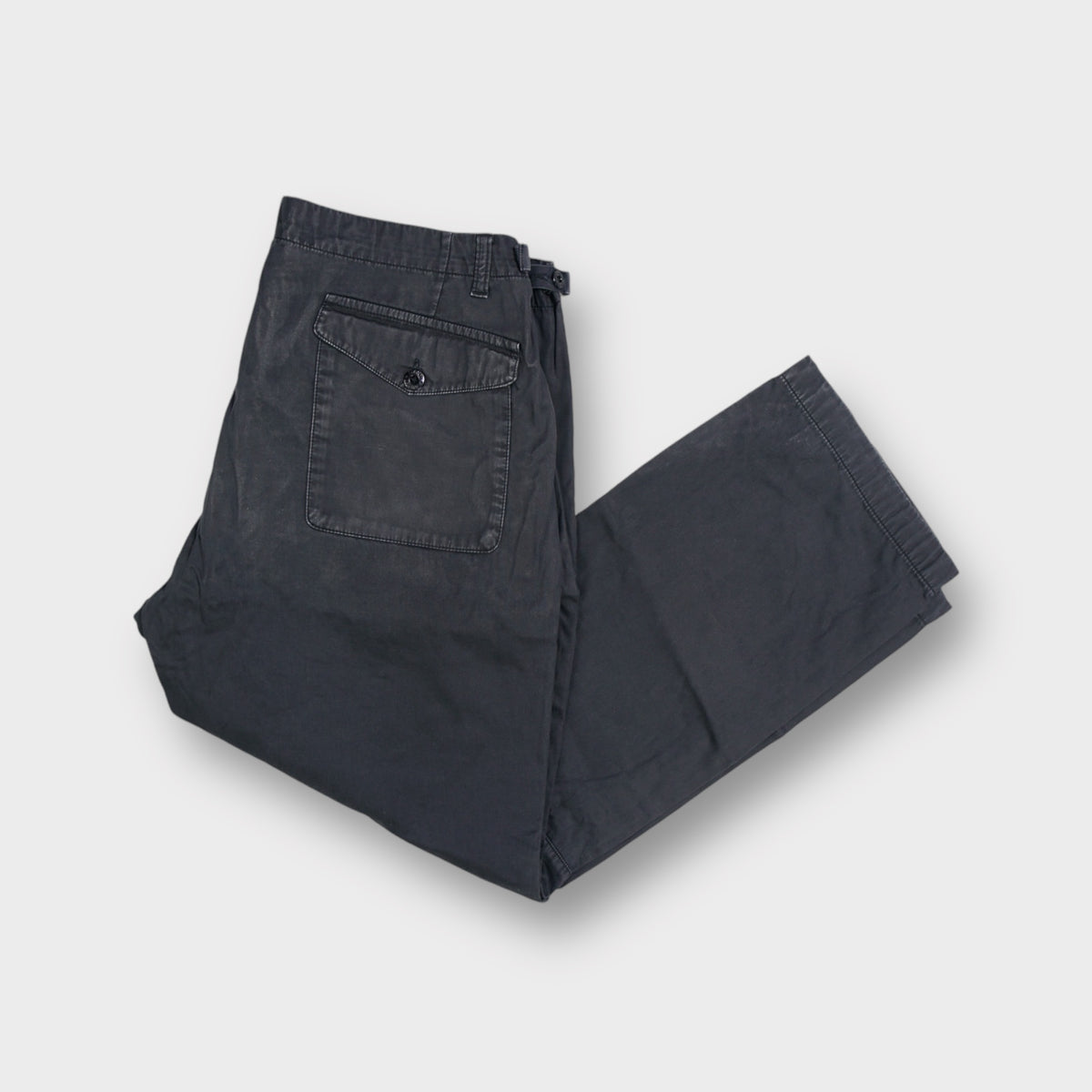 Stone Island blue pants featuring side zip pockets and a woven inner waistband tag