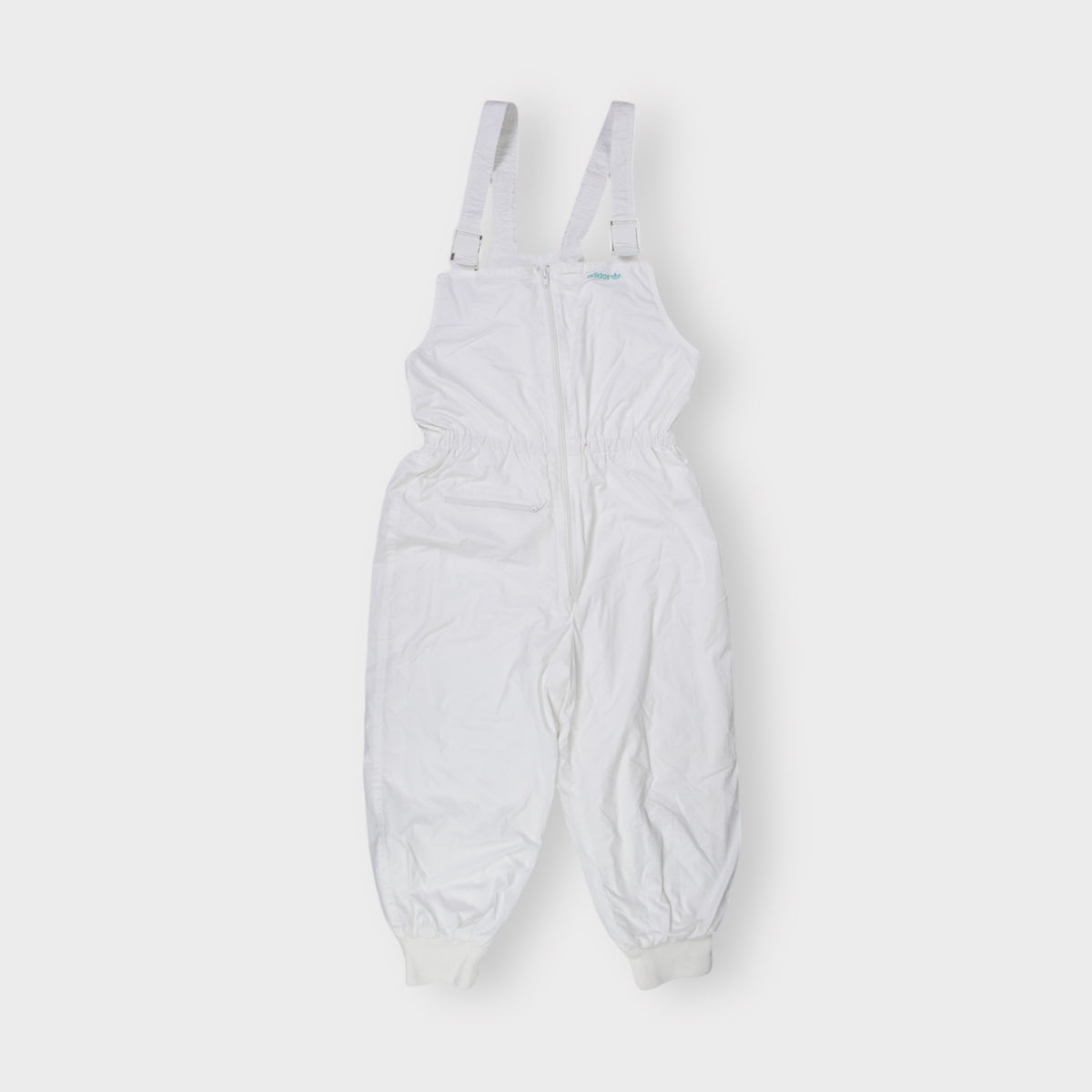 Adidas white dungarees featuring an embroidered teal Trefoil chest logo