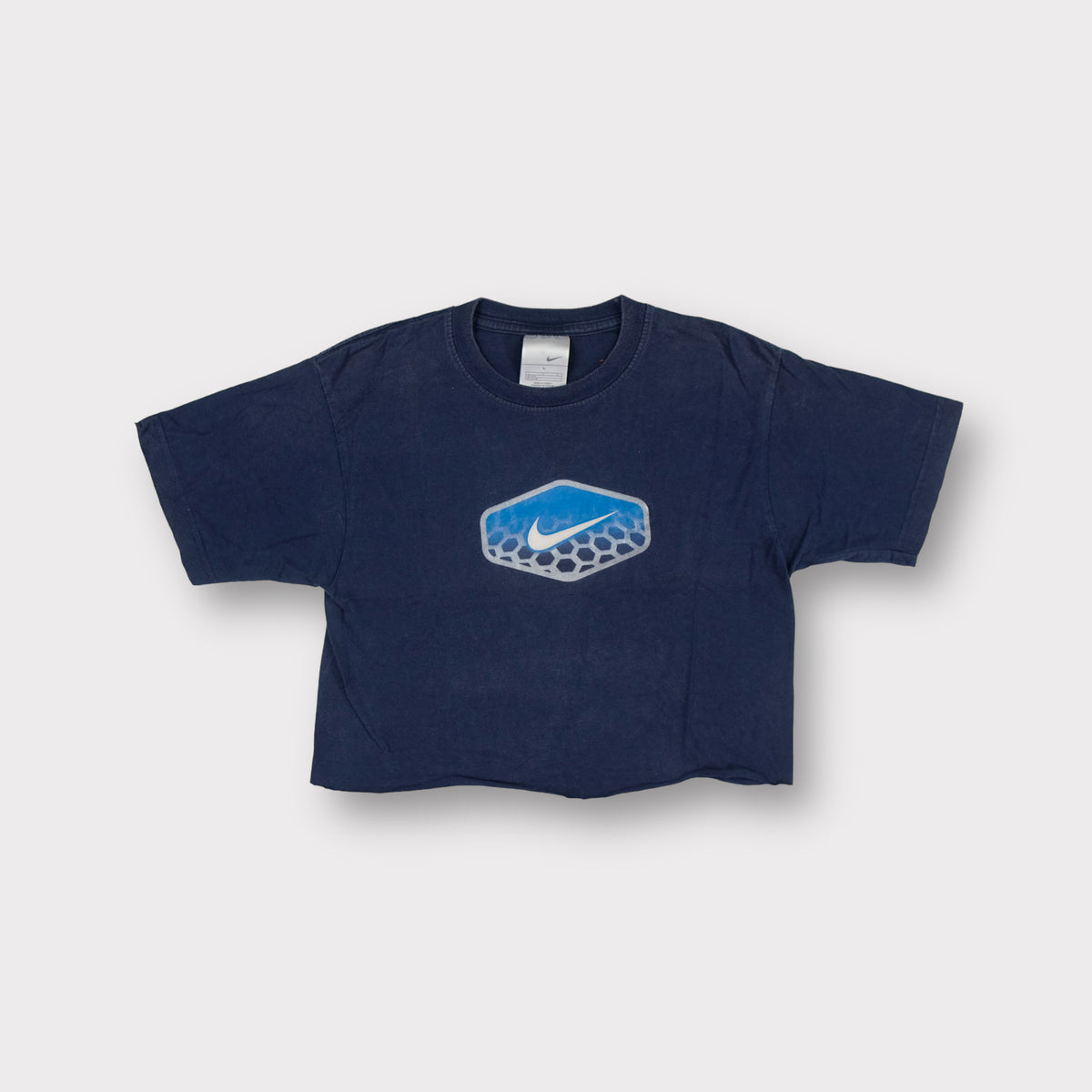 Nike T-Shirt in dark blue with a light blue honeycomb swoosh graphic on chest
