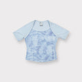 Nike short-sleeve shirt in light blue with an abstract printed panel on the front.