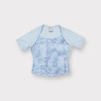 Nike short-sleeve shirt in light blue with an abstract printed panel on the front.