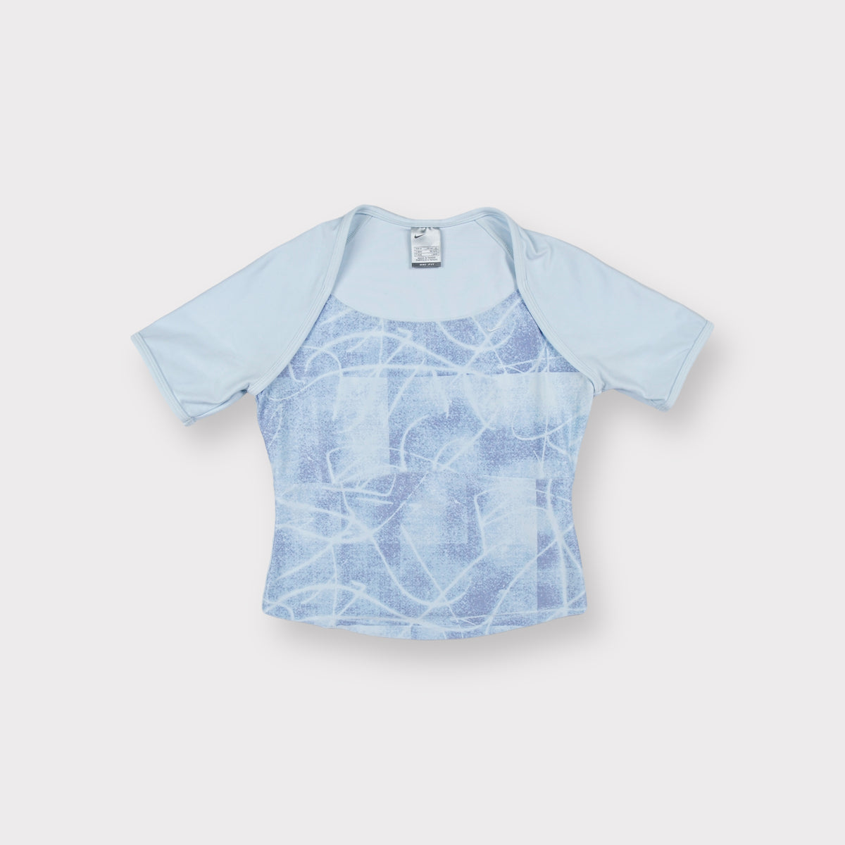 Nike short-sleeve shirt in light blue with an abstract printed panel on the front.