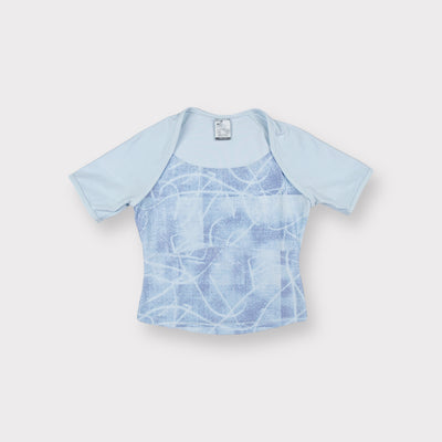 Nike short-sleeve shirt in light blue with an abstract printed panel on the front.