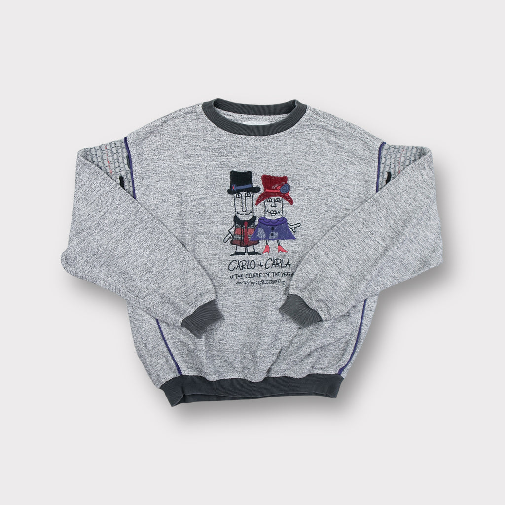 Grey Carlo Colucci sweater featuring a Carlo and Carla embroidered character graphic.