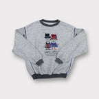 Grey Carlo Colucci sweater featuring a Carlo and Carla embroidered character graphic.