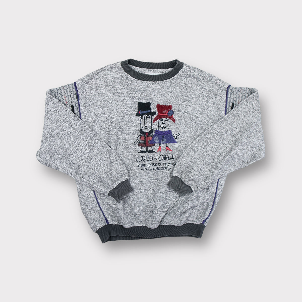 Grey Carlo Colucci sweater featuring a Carlo and Carla embroidered character graphic.