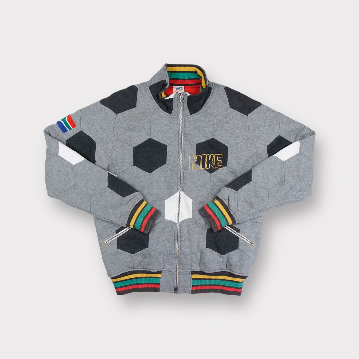 Nike grey full-zip jacket featuring a football panel pattern and embroidered chest logo
