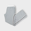 Grey Nike trackpants with black and white side stripes and embroidered swoosh