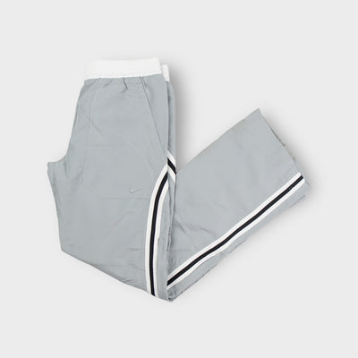Grey Nike trackpants with black and white side stripes and embroidered swoosh