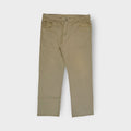 Lee khaki jeans featuring a brown leather logo patch on the back waistband