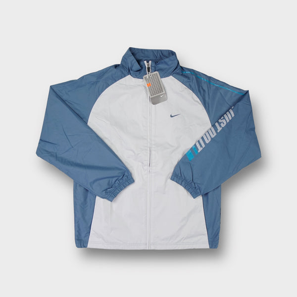 Nike blue and grey track jacket with Just Do It print on the sleeve