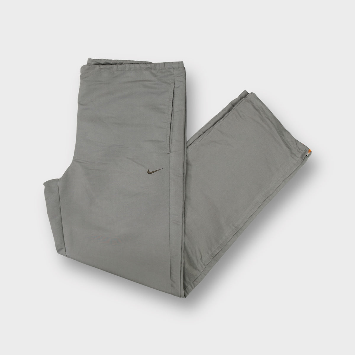 Nike khaki trackpants with embroidered swoosh and olive green leg stripe detail