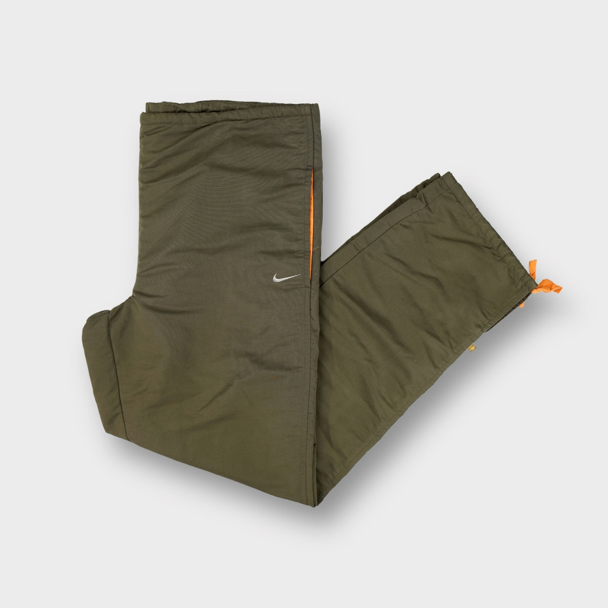 Nike trackpants in olive green with orange trim and small silver swoosh logo