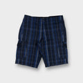 Nike shorts in blue plaid pattern featuring side cargo pockets and button closure