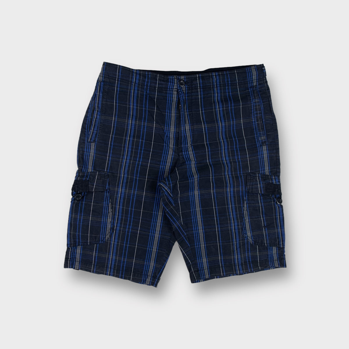 Nike shorts in blue plaid pattern featuring side cargo pockets and button closure