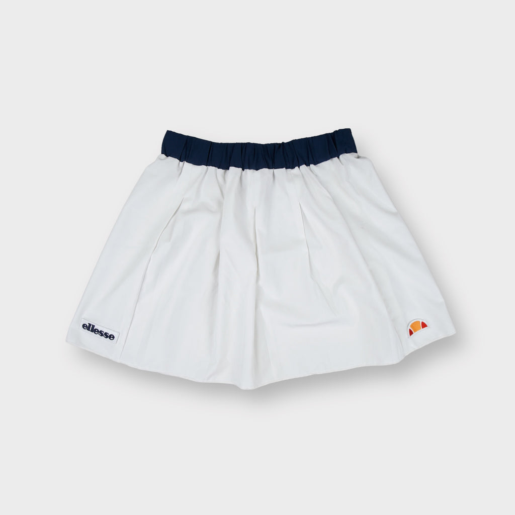Ellesse tennis skirt in white with dark blue waistband and lower hem logo patches