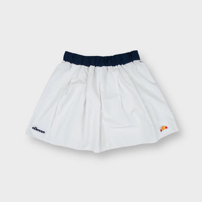 Ellesse tennis skirt in white with dark blue waistband and lower hem logo patches