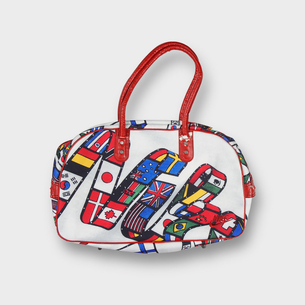 Nike 1984 Olympic Games bag in white with red handles and national flag script graphic.