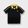 Puma short-sleeve shirt in black with a yellow collar and Pelé embroidered chest logo.