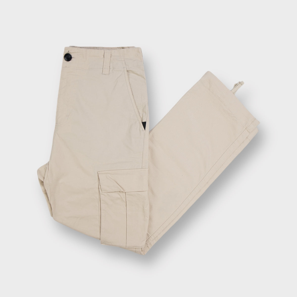 Nike SB beige ripstop cargo trousers featuring large side flap pockets and adjustable hem ties