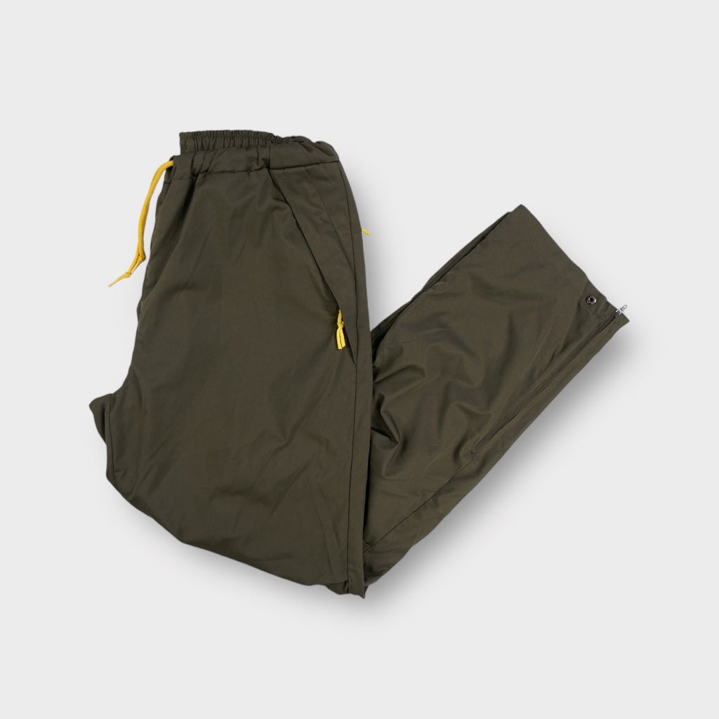 Nike khaki trackpants with yellow drawstring waistband and side zipper details