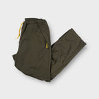 Nike khaki trackpants with yellow drawstring waistband and side zipper details