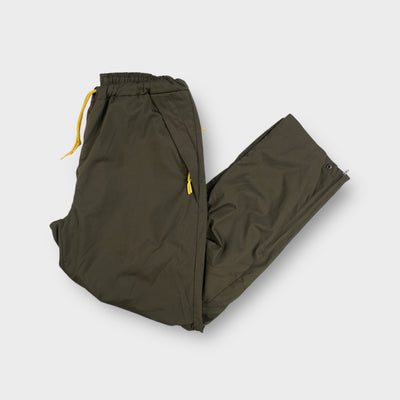 Nike khaki trackpants with yellow drawstring waistband and side zipper details