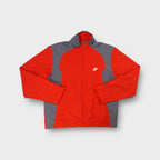 Nike track jacket in red and grey featuring an embroidered white logo on the chest.