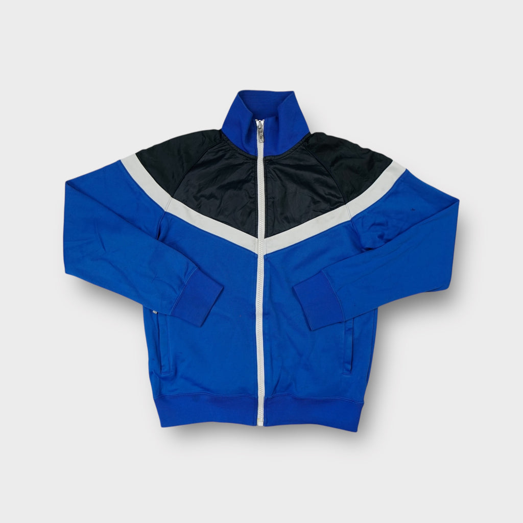 Blue Nike track jacket featuring a black and white chevron panel across the chest