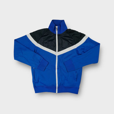 Blue Nike track jacket featuring a black and white chevron panel across the chest