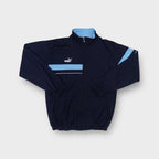 Puma black track jacket featuring a light blue chest panel and embroidered logo