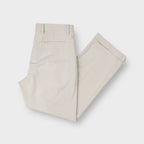 Nike beige golf trousers featuring front pleats and folded cuffed hems