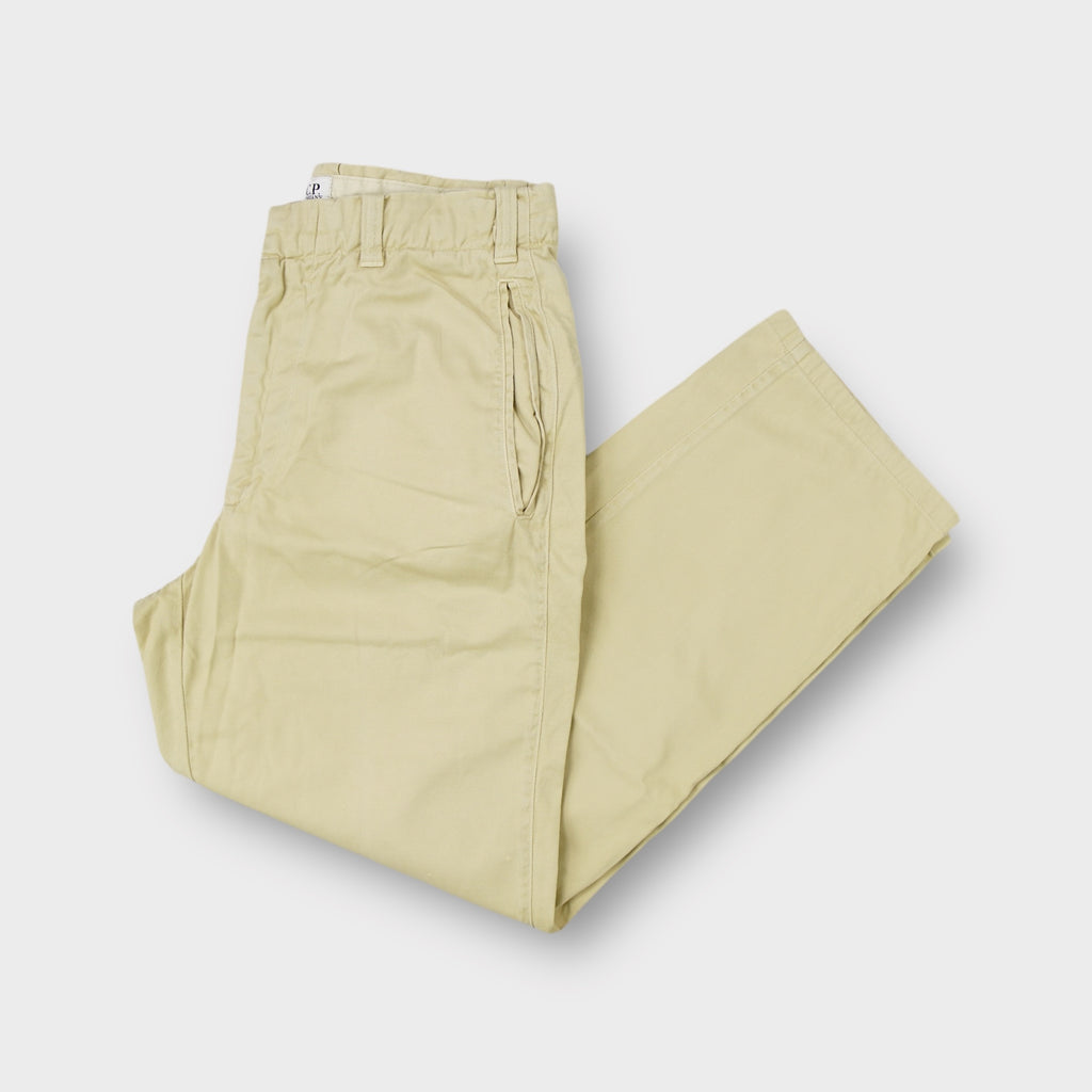 C.P. Company trousers in beige featuring side entry pockets and elastic waist inserts
