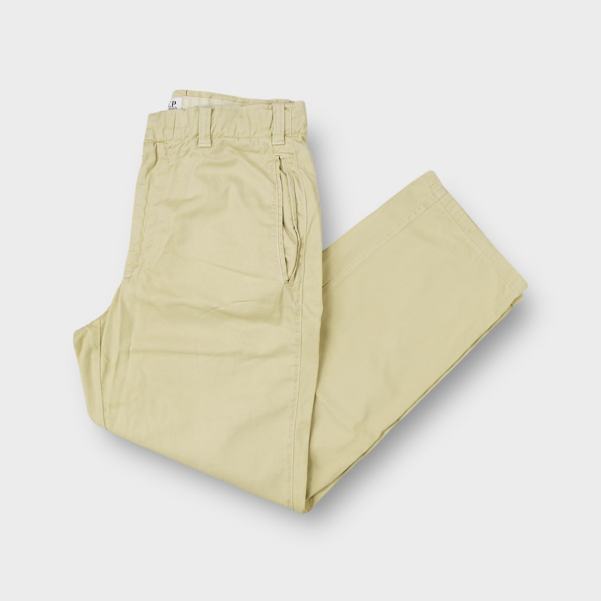 C.P. Company trousers in beige featuring side entry pockets and elastic waist inserts