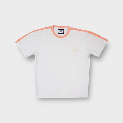 White Umbro T-Shirt featuring orange collar trim and small yellow embroidered chest logo