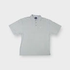 Grey Asics polo shirt featuring an embroidered chest logo and tortoise-shell buttons