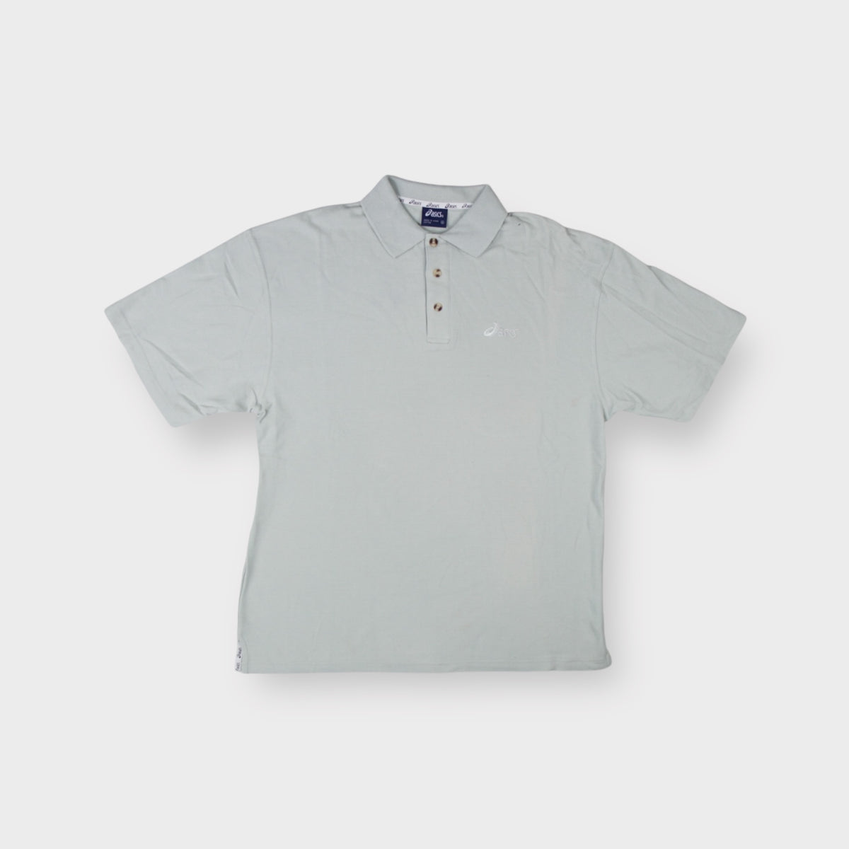 Grey Asics polo shirt featuring an embroidered chest logo and tortoise-shell buttons
